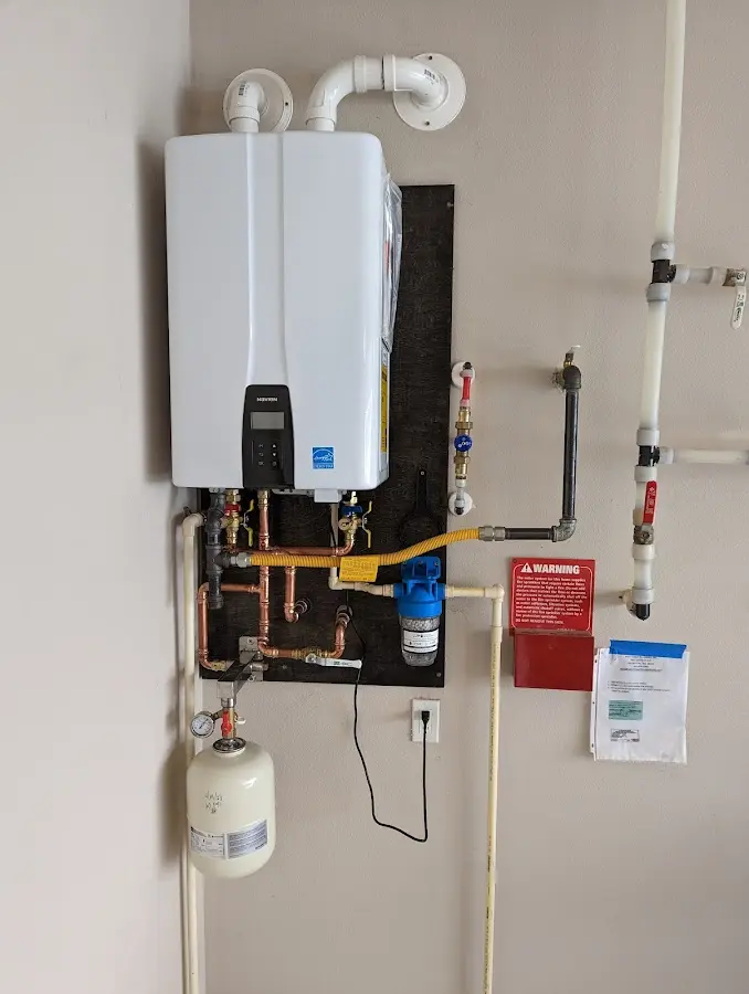 Professional plumber installing copper piping in a Oak Brook home